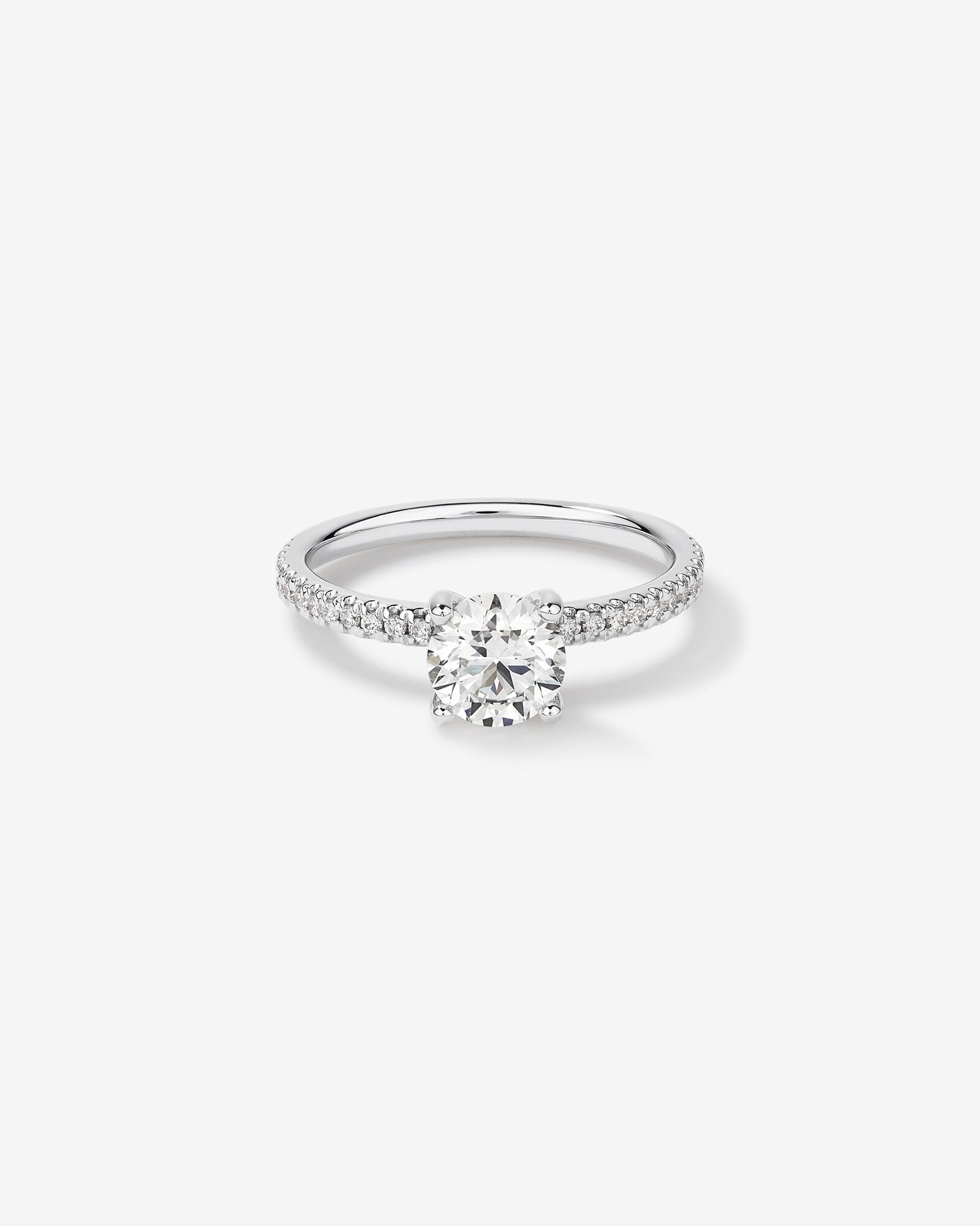 1.14 Carat TW of Diamonds Engagement Ring with a 1 Carat Round Centre Laboratory-Grown Diamond and shouldered by 0.14 Carat TW Revat Jewels