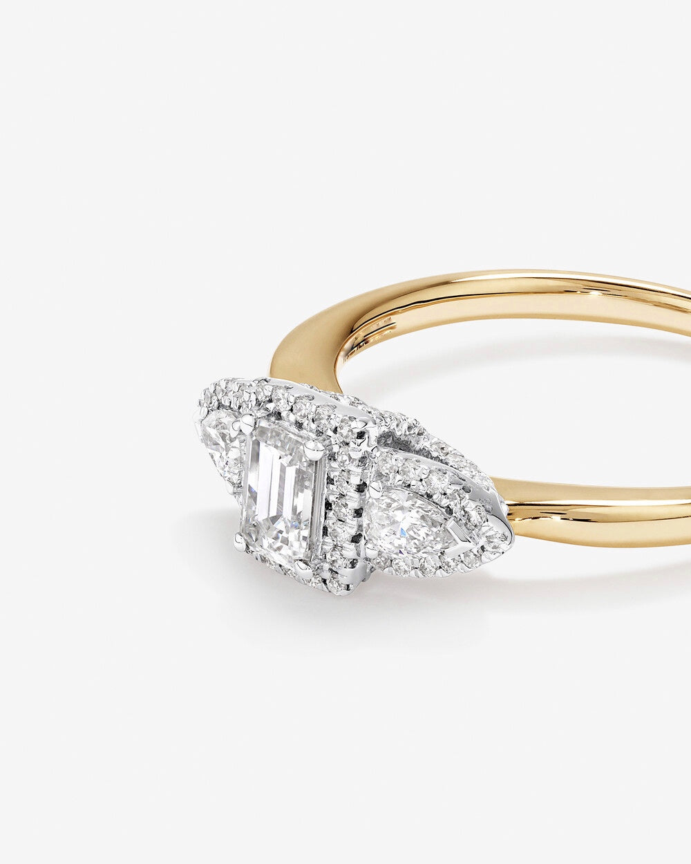 0.69 Carat TW Three Stone Emerald and Pear Cut Diamond Halo Engagement Ring in 14kt Yellow and White Gold Revat Jewels